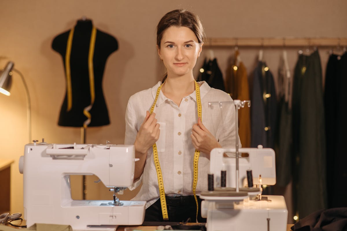 Studio founder at the cutting table, measuring linen
