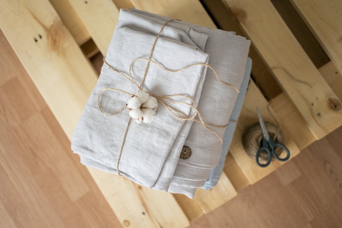 Folded linen pieces tied with raw twine, ready to ship