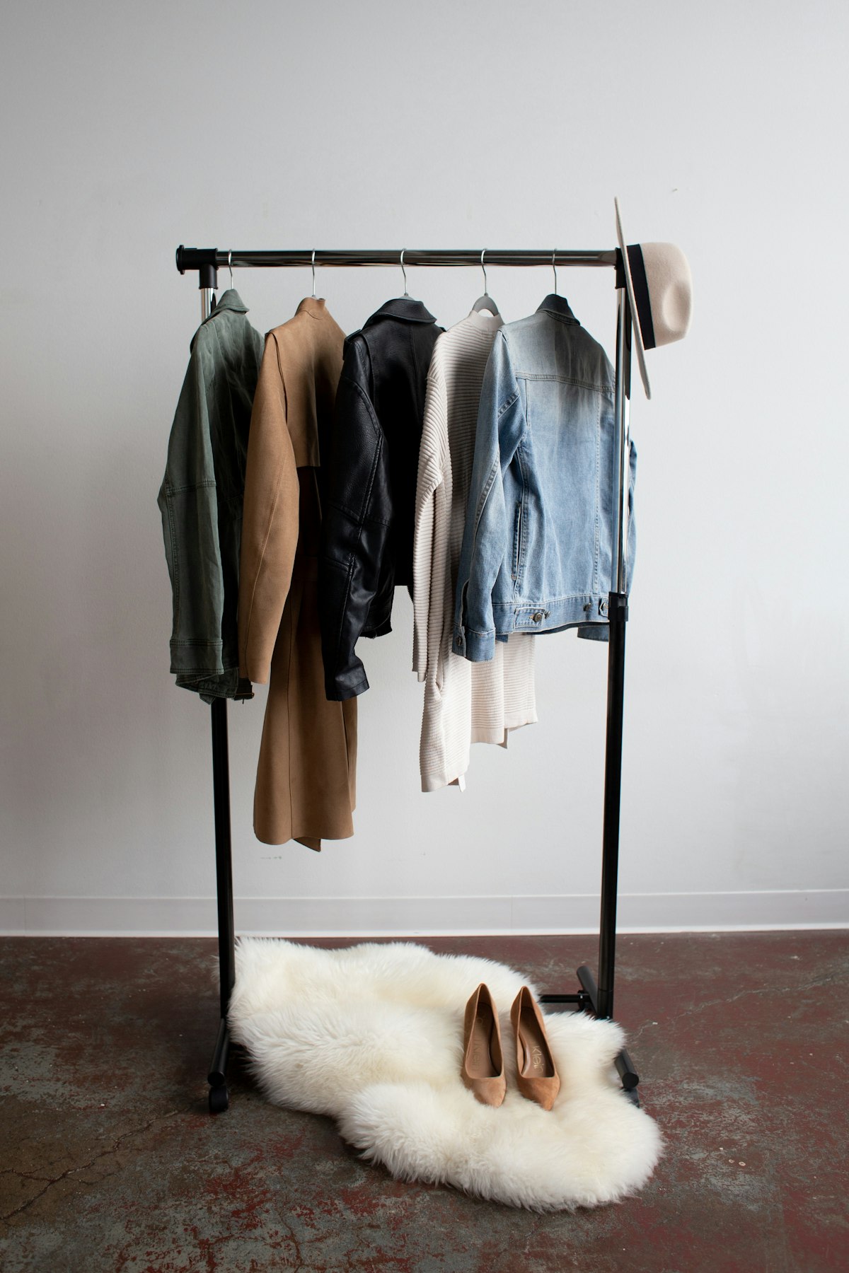 Camel wool coat on a styled wardrobe rack